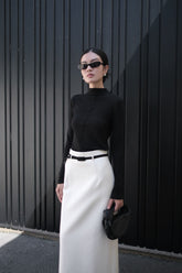 Long-sleeve knit top with mock neckline and seam detail for structured minimalist styling